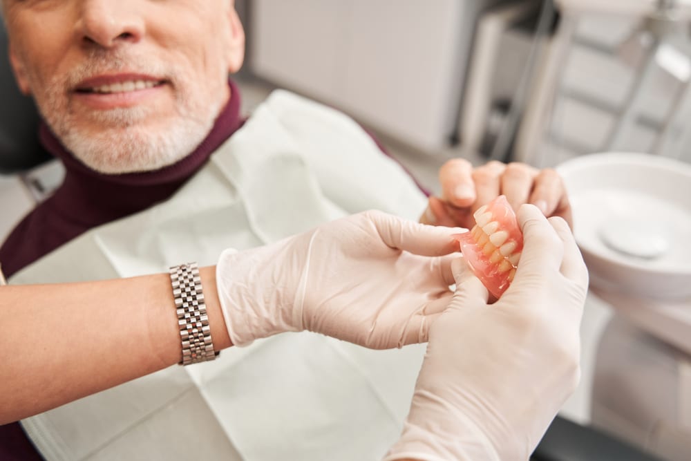 The Pros and Cons of Dentures and Dental Implants Dr. Aaron Goodman Dr. Matthew Young Dr. Aaron English. Prairie Hawk Dental. General, Cosmetic, Restorative, Preventative Family Dentistry. Dentist in Castle Rock, CO 80109