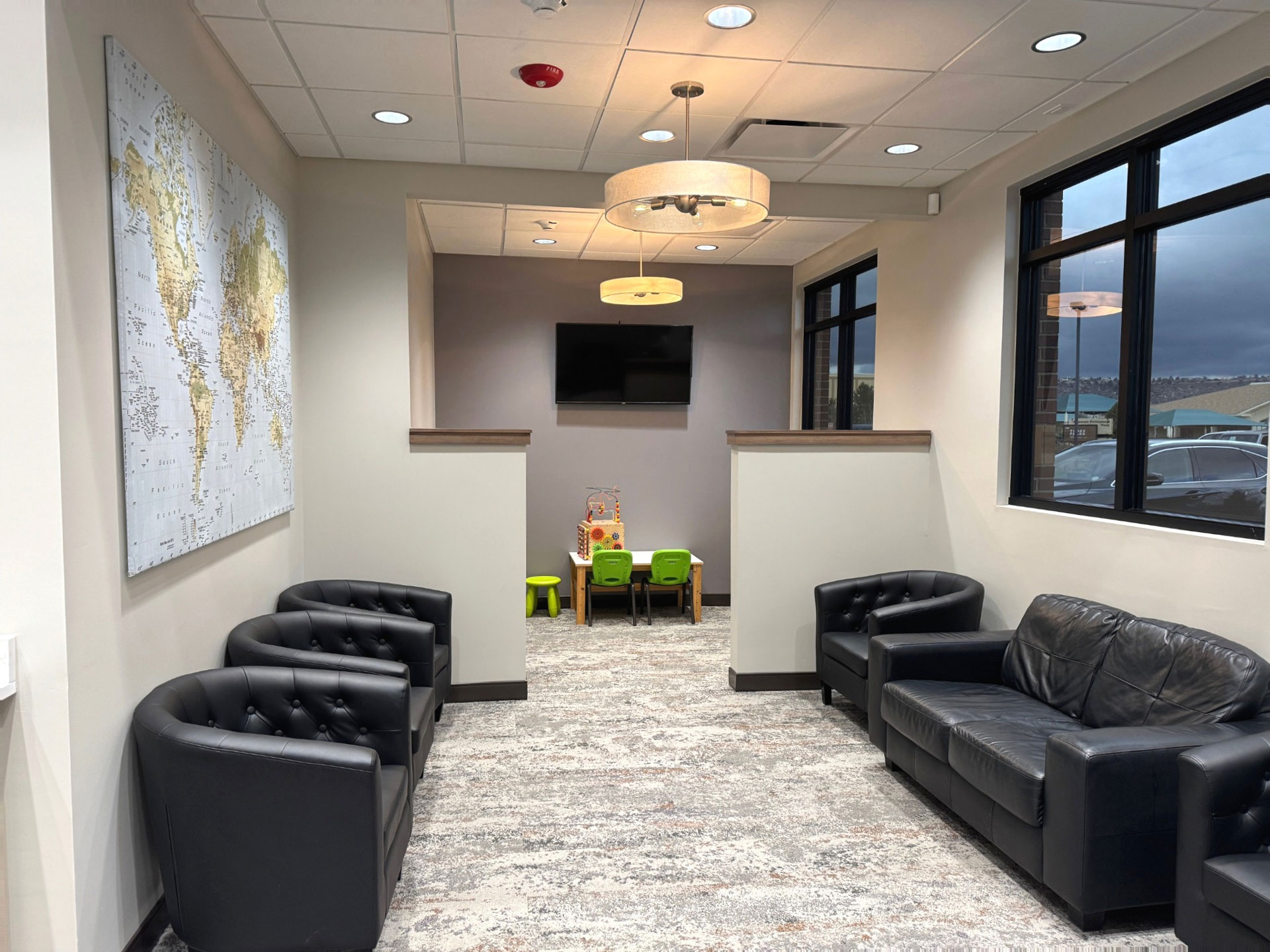 Modern waiting area with black leather seating at Prairie Hawk Dental in Castle Rock, CO