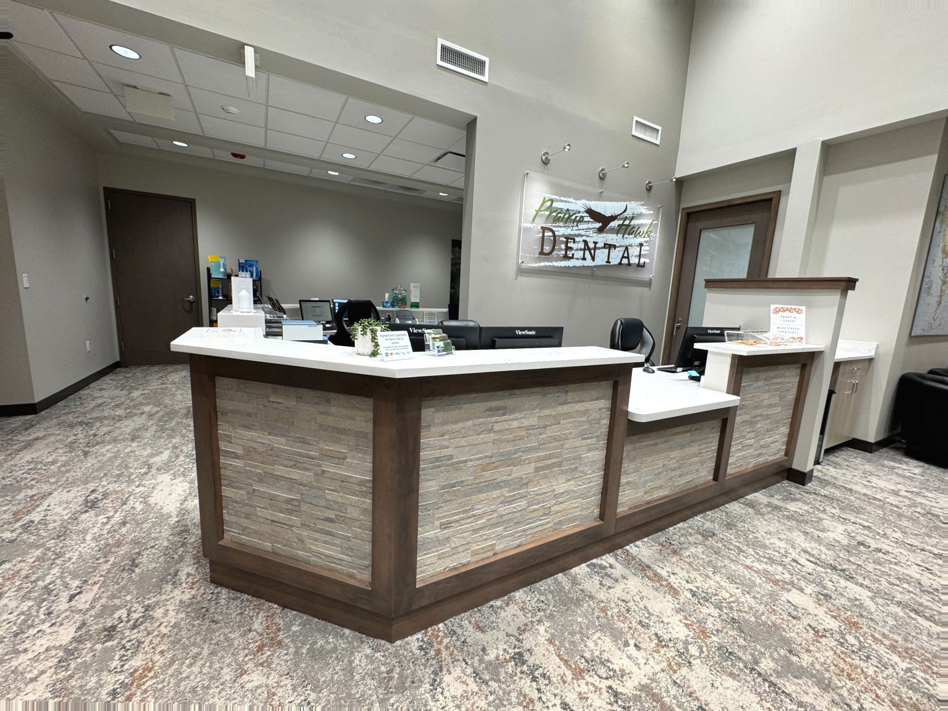 Reception desk at Prairie Hawk Dental in Castle Rock, CO with computers and signage
